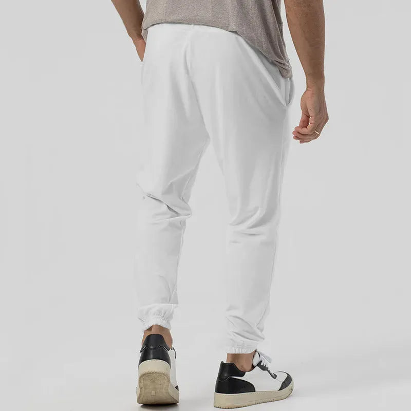 Men's grey cotton blend track sweatpants with elastic waistband and straight-leg tapered design