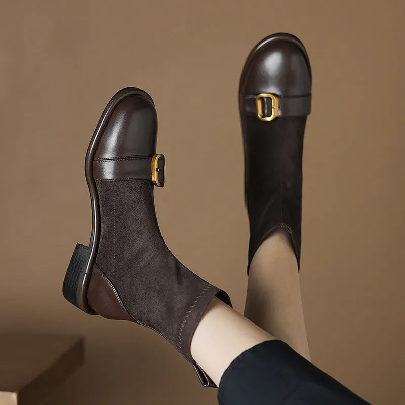 Black women's Martin-style ankle boots with lace-up front, round toe, and low heel on a white background.