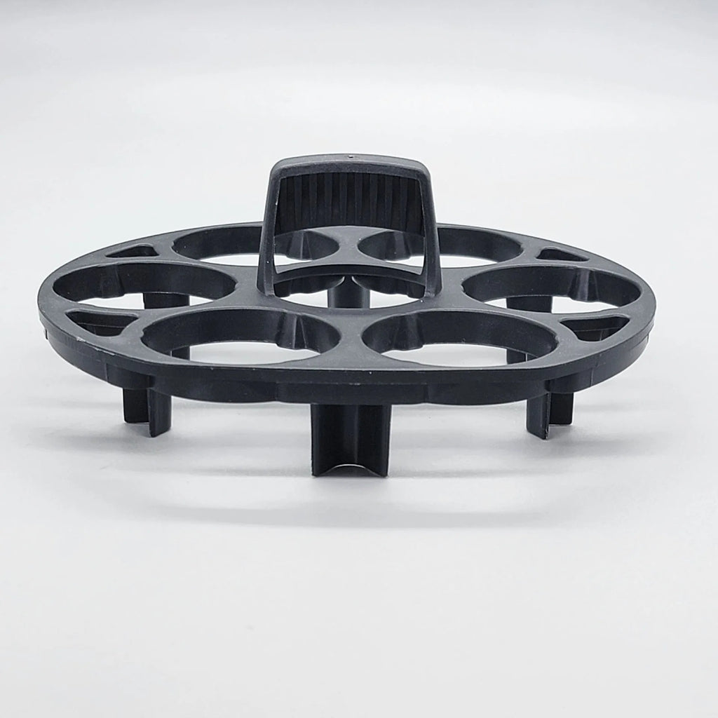 Modern black plastic egg holder tray measuring 13.8 by 12.6 by 5.7 centimetres on a kitchen counter.
