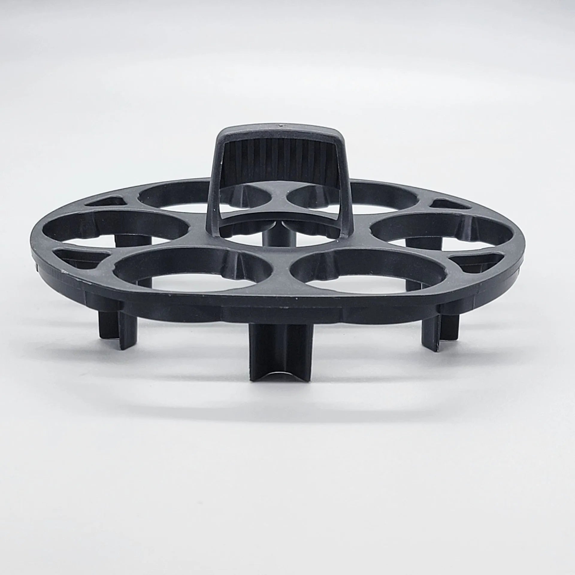 Modern black plastic egg holder tray measuring 13.8 by 12.6 by 5.7 centimetres on a kitchen counter.