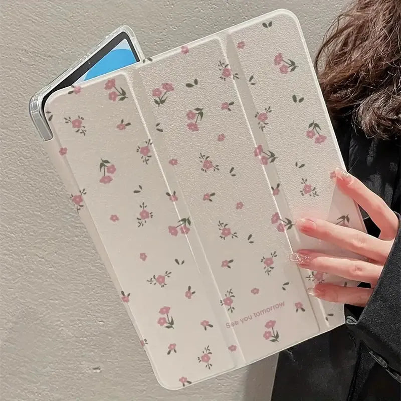 Transparent floral tri-fold hard case for iPad showing magnetic closure and stylus loop.