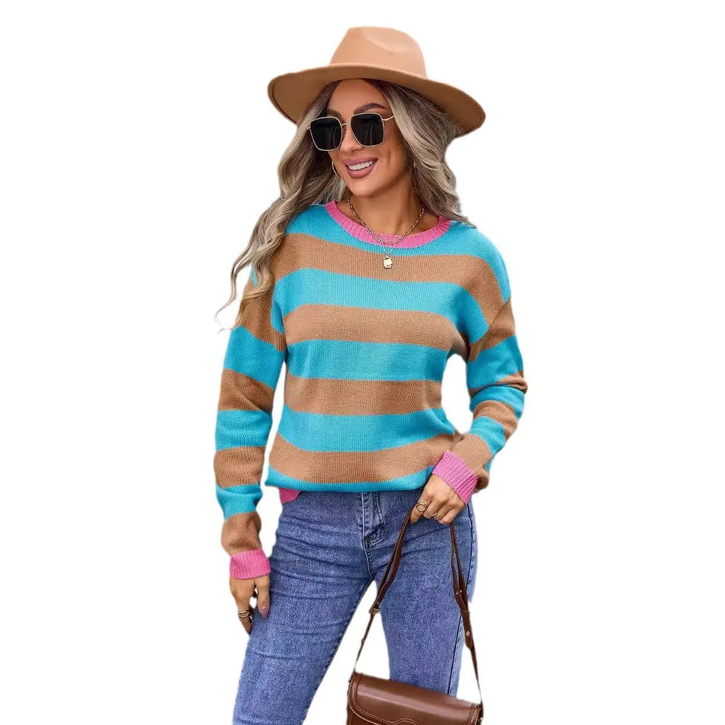 Women's loose fit long sleeve acrylic sweater in blue with a striped pattern, showing round neck.