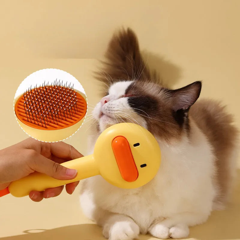 Small yellow duck-shaped pet grooming comb with needle head for hair removal on cats and dogs.