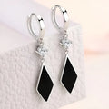 Silver geometric drop ear clip earrings with a vintage diamond pattern.