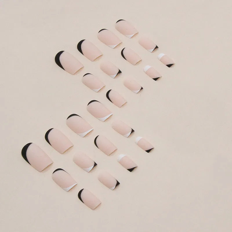 Black and white frosted gel manicure set with plastic nail armour pieces.