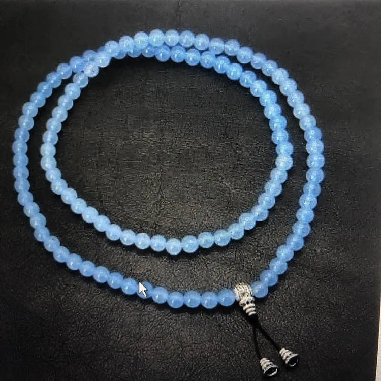 Natural stone bracelet with alloy volcano white turquoise centrepiece and mixed tiger eye beads on white background
