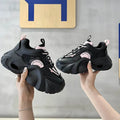 Women's pink casual sneakers with cross shoulder straps, thick sole, and mesh lining on a white background.