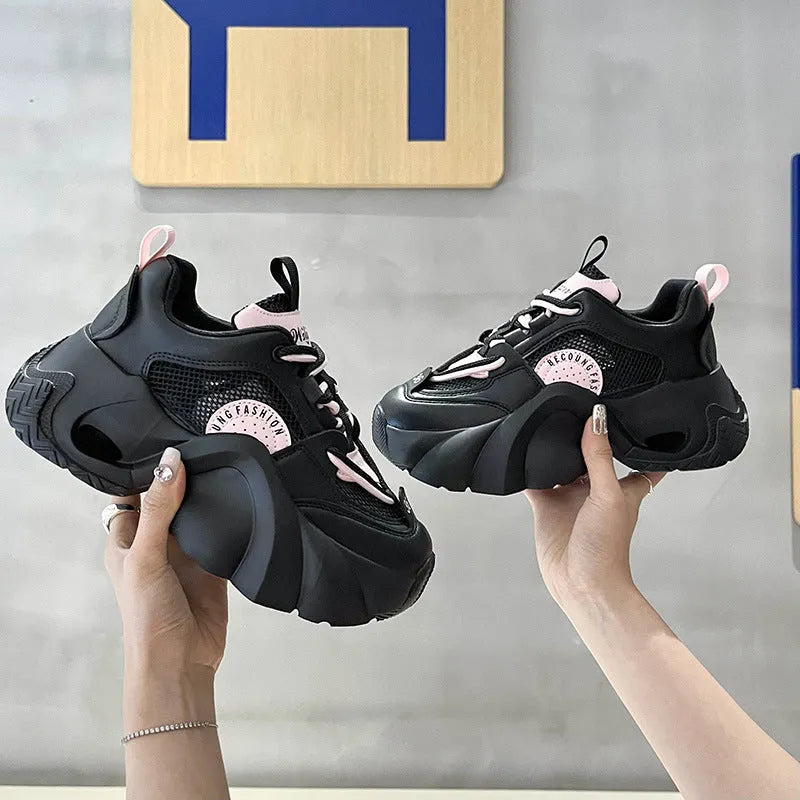 Women's pink casual sneakers with cross shoulder straps, thick sole, and mesh lining on a white background.