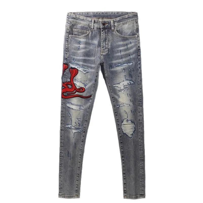 Washed-out old colour slim fit jeans with distressed patches and embroidery detail