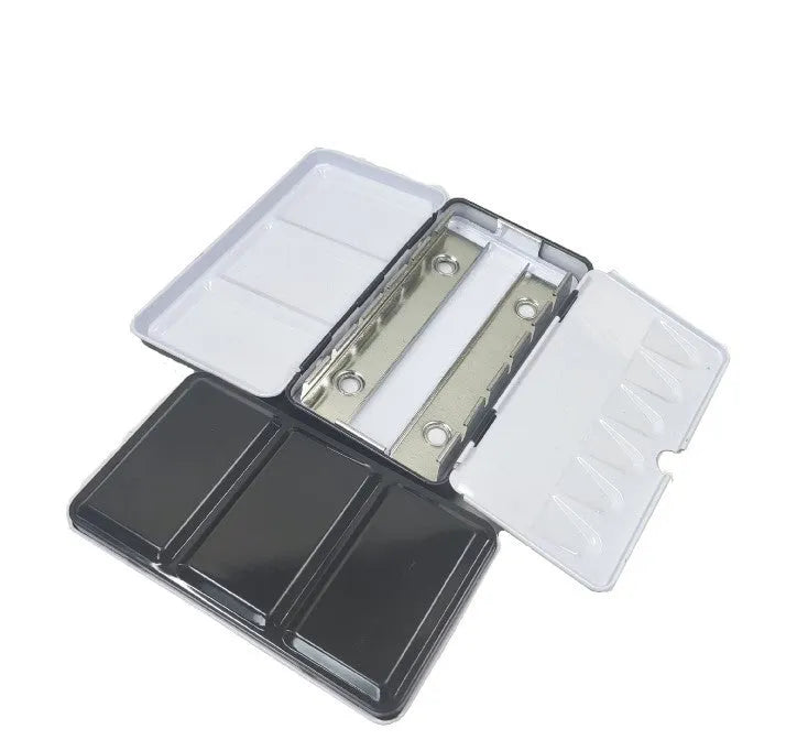 Solid tinplate paint box for watercolour pigments in a three-fold square design.
