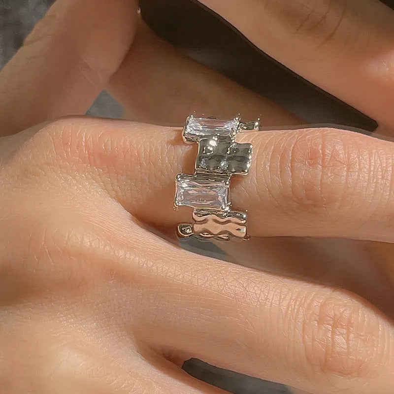 Silver geometric cross ring with open zircon stone setting and retro design