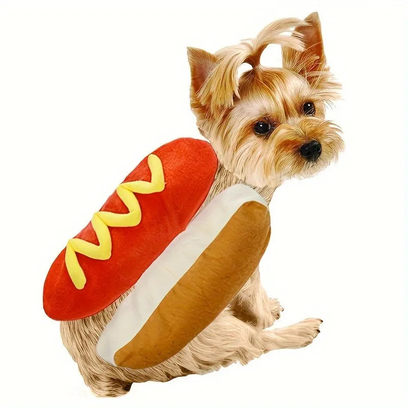 A small dog wearing a plush red and brown hot dog costume with elastic straps.