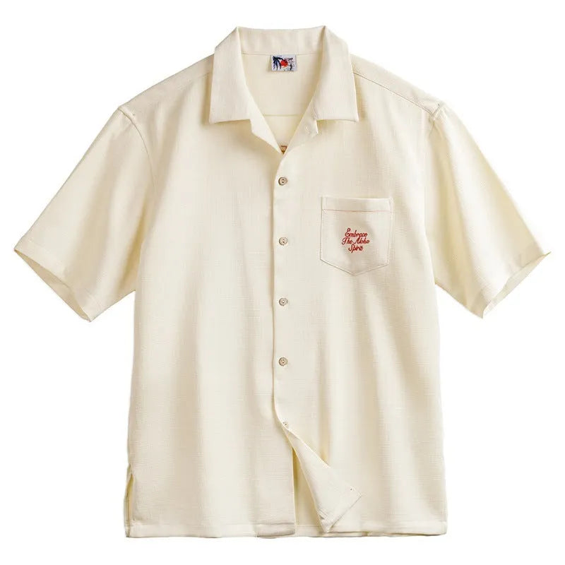 Light apricot men's shirt with bamboo print and a Cuban collar laid flat.