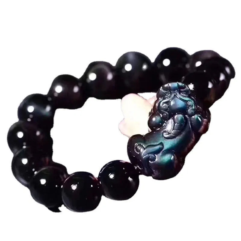 Natural ice colour eye obsidian crystal bead bracelet on a wrist, showing unisex design.