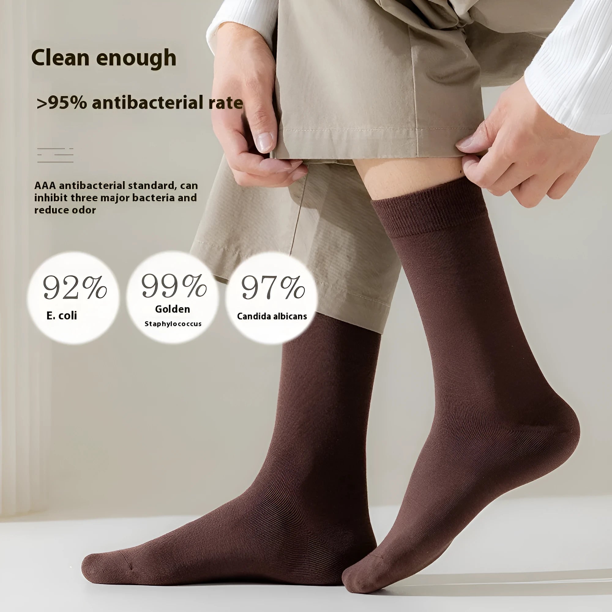 Pack of men's solid colour mid-calf business socks in combed cotton on a neutral background.
