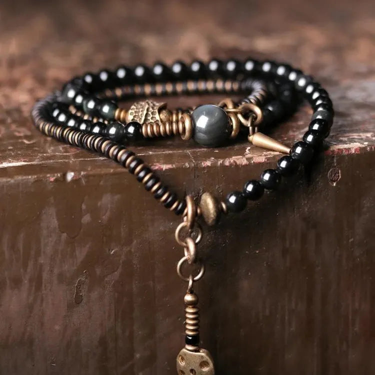 Unisex black beaded geometry multi-layered bracelet with natural style on plain background