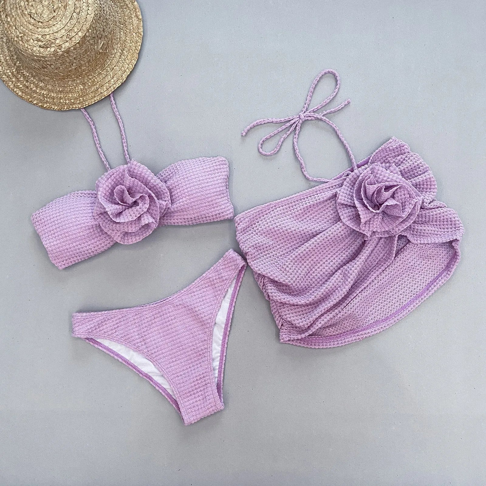 Women's white 3D flower split three-piece bikini set on a mannequin.