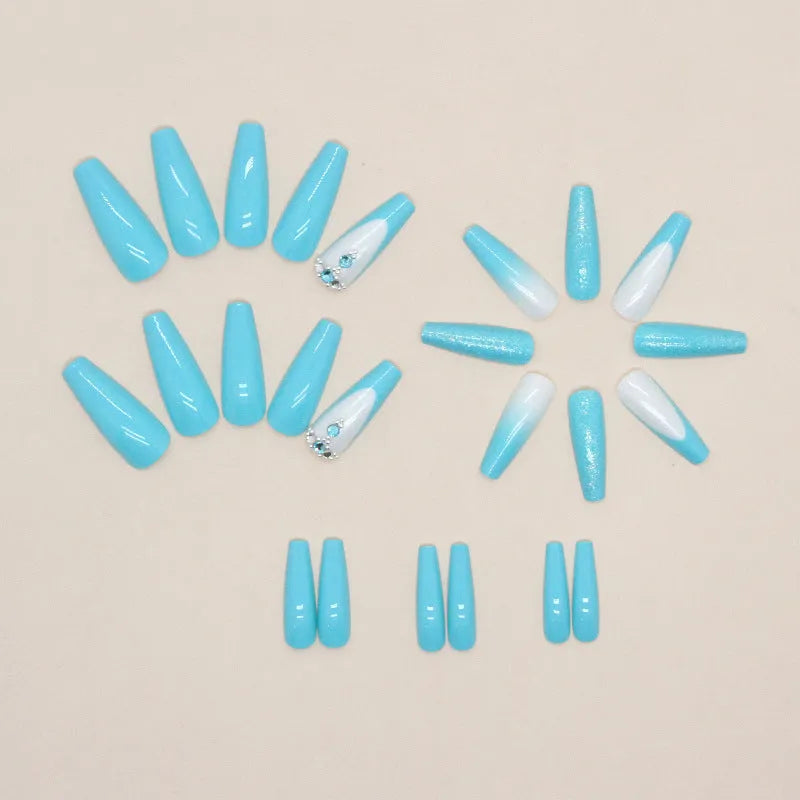 Long ballet-shaped false nails with solid blue colour and smart diamond glitter, shown with glue.