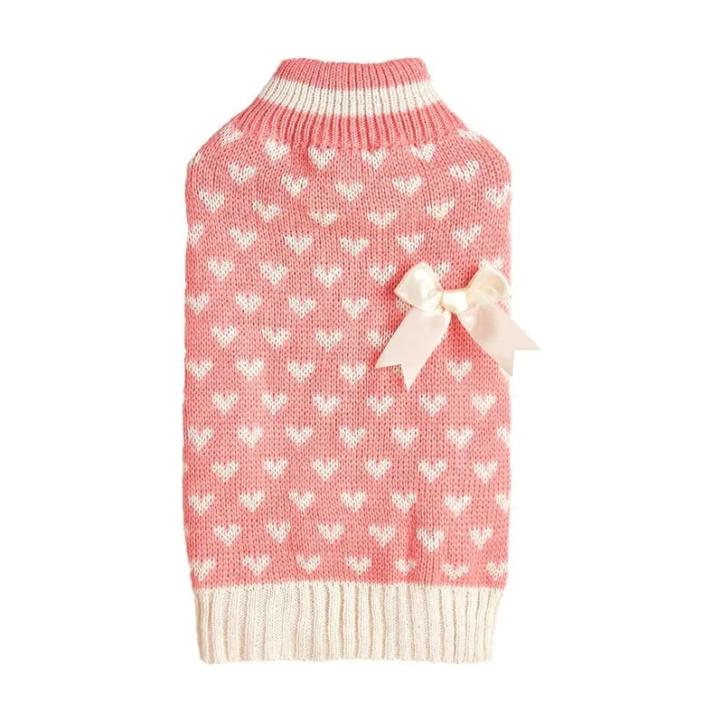 Dog wearing red love heart and pink bow decorated acrylic sweater