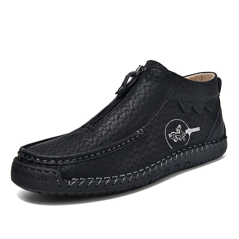 Men's black slip-on leather loafers with a round toe and flat rubber sole, shown on a foot.