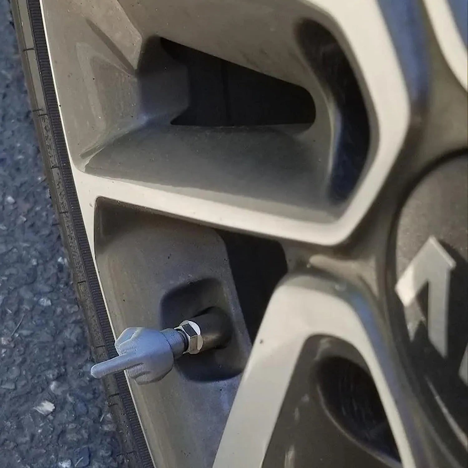 Eight car tyre valve caps, four black and four beige, made from latex rubber with standard threads