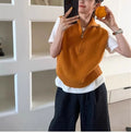 Retro half-zip sleeveless knit vest in mesh fabric, shown in orange colour with a 3D pattern.