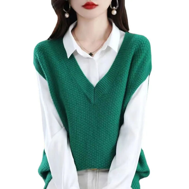Creamy-white V-neck sleeveless knit vest with a raised 3D pattern texture, laid flat.