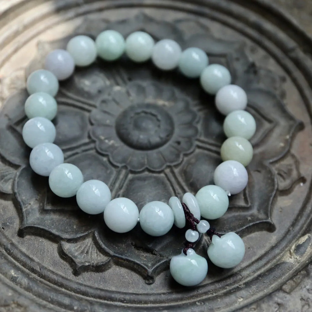 Natural emerald green jade hanging bracelet with Maitreya Buddha design on a geometric shape.