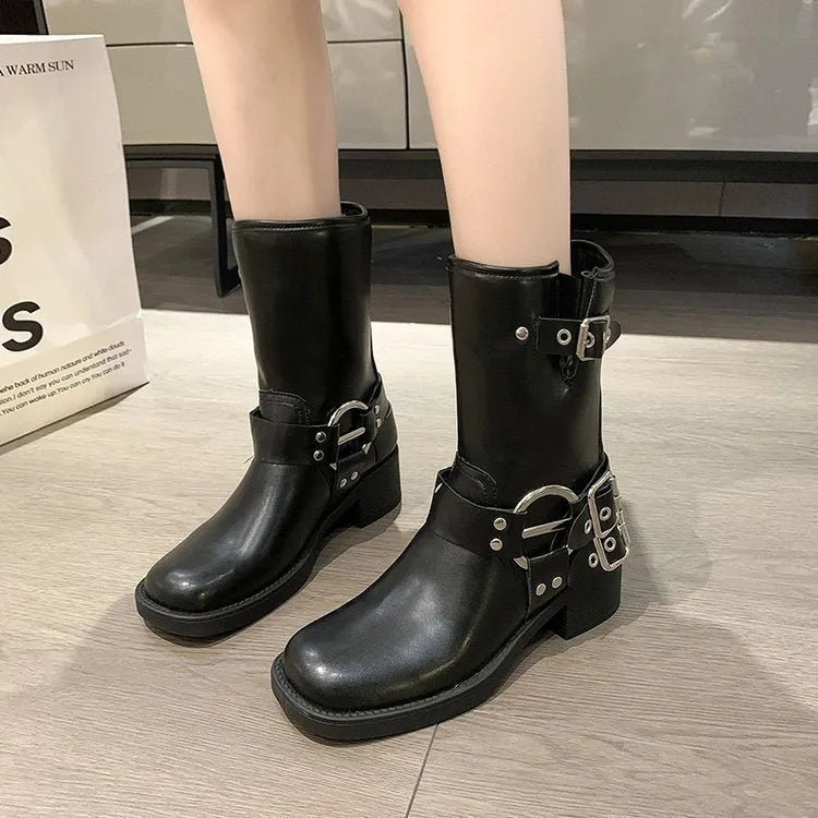 Black platform calf-length women's boots with a large decorative buckle on the shaft.