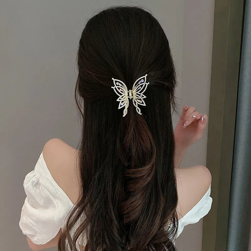 Women's butterfly-shaped alloy hair clip in rhinestone or pearl style, measuring 6.7 cm.