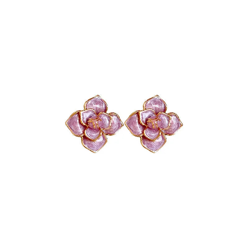 A pair of purple and gold floral stud earrings with detailed needlework and an oil-spot glaze finish.