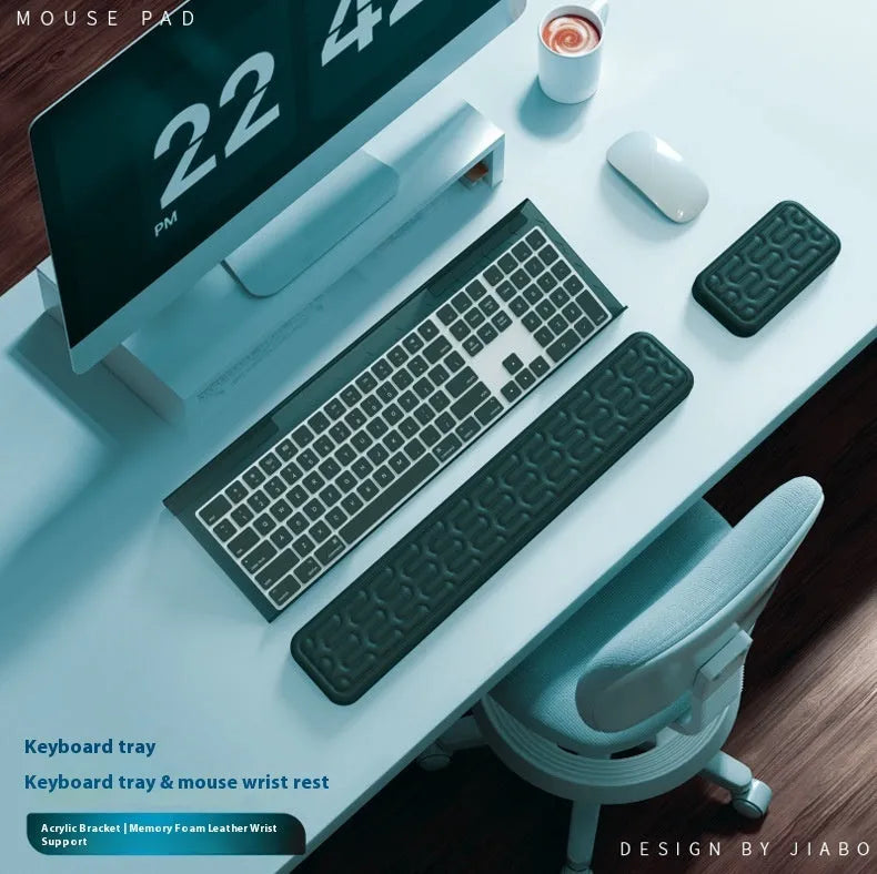 Memory foam keyboard and mouse pad with wrist rest in various colours on a desk