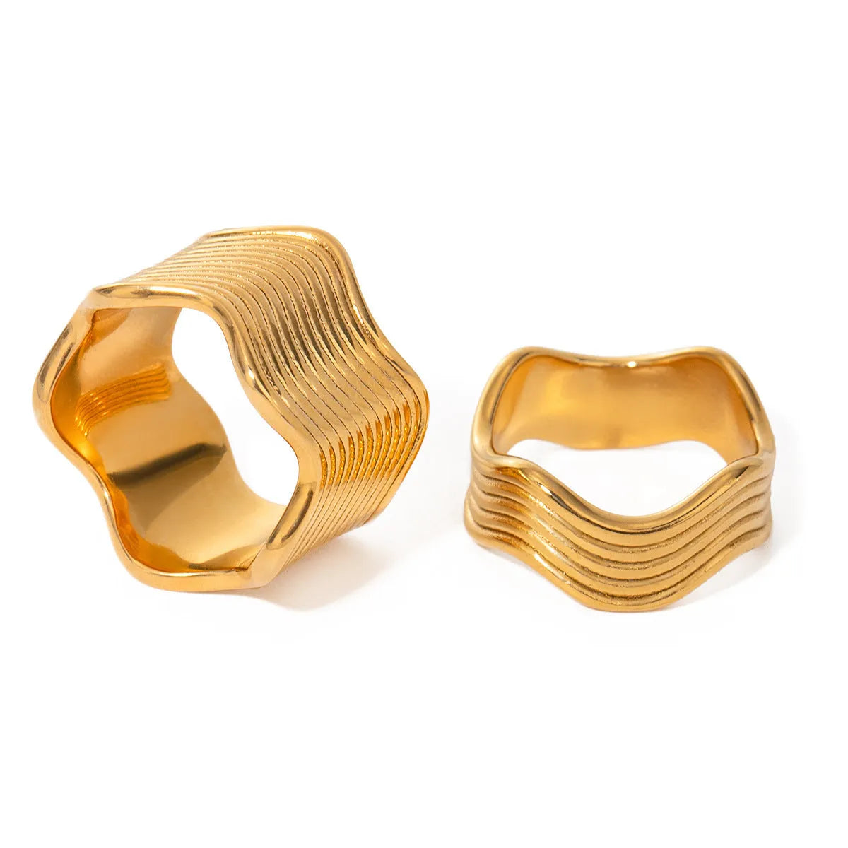 Stainless steel geometric wave pattern ring on a hand, showcasing its wide band and electroplated finish.