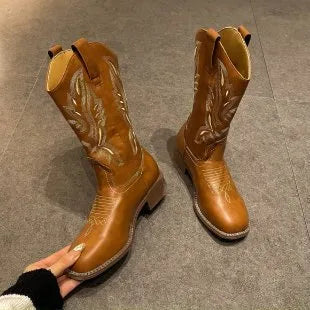 Brown women's mid-calf boots with embroidery detail on the shaft, shown from the side.