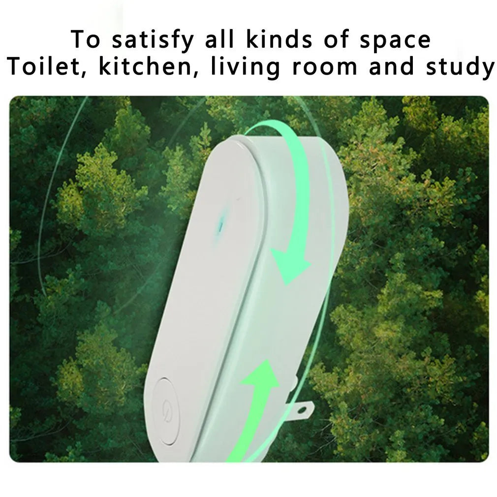 Small negative ion air purifier in black, plugged into a wall socket, with a room in the background
