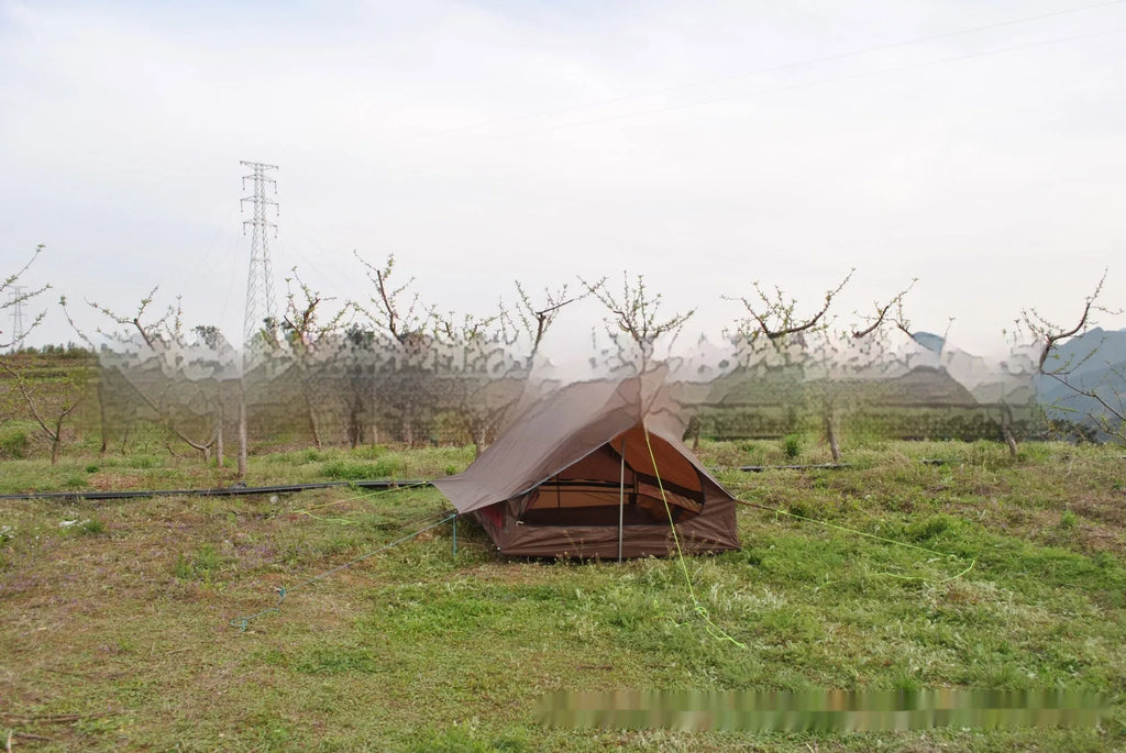 Brown A-frame hiking tent supported by hiking poles showing spacious interior for 2-3 campers