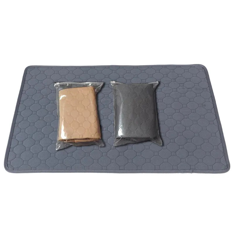 Two washable dog pee pads in grey and khaki on a floor, one with a small dog standing on it