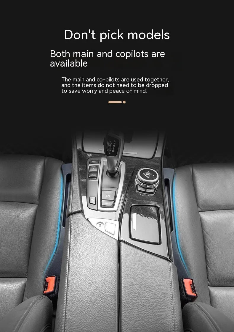 Black plastic car seat gap storage box with handle inserted between vehicle front seats.