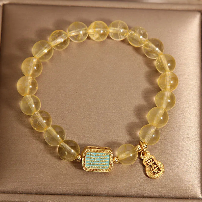Natural citrine yellow crystal bracelet for women with rhinestone accents on a white background