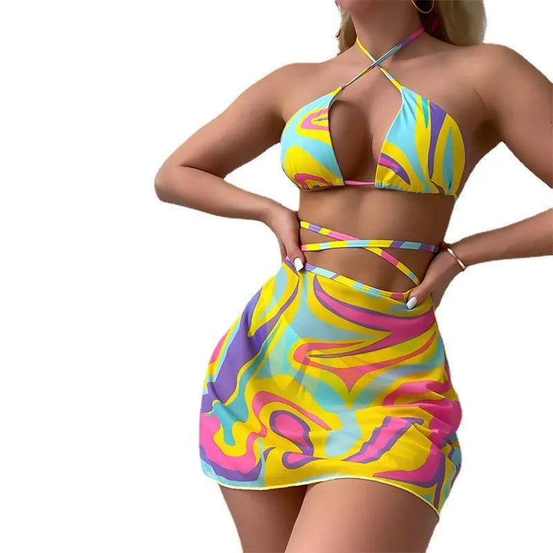 Women's yellow halter lace-up striped swimsuit set with top, skirt, and shorts on a model