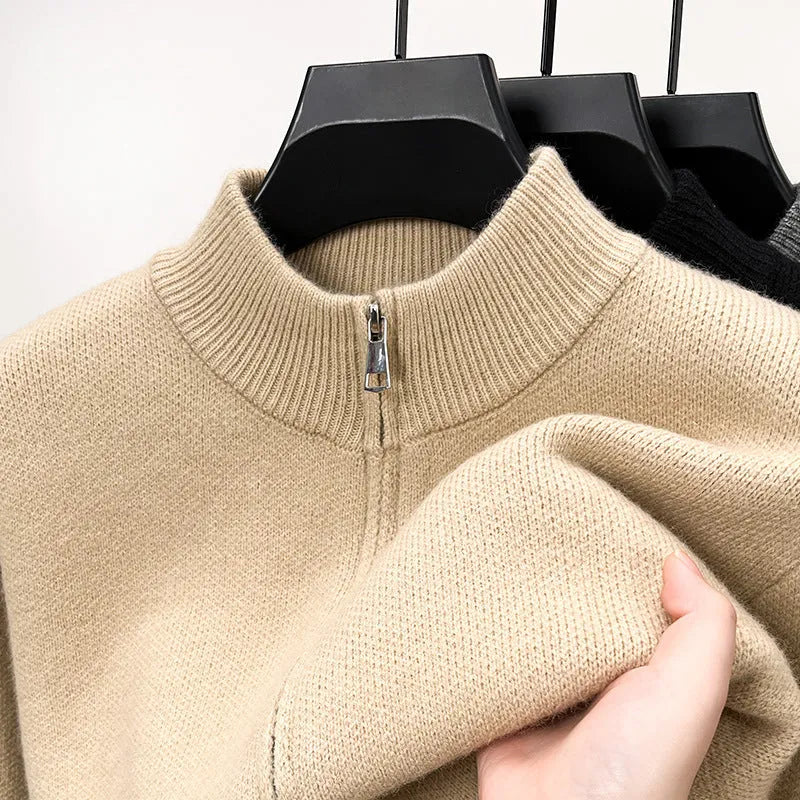 Men's black zip-up knitted cardigan with a stand collar, shown on a model.
