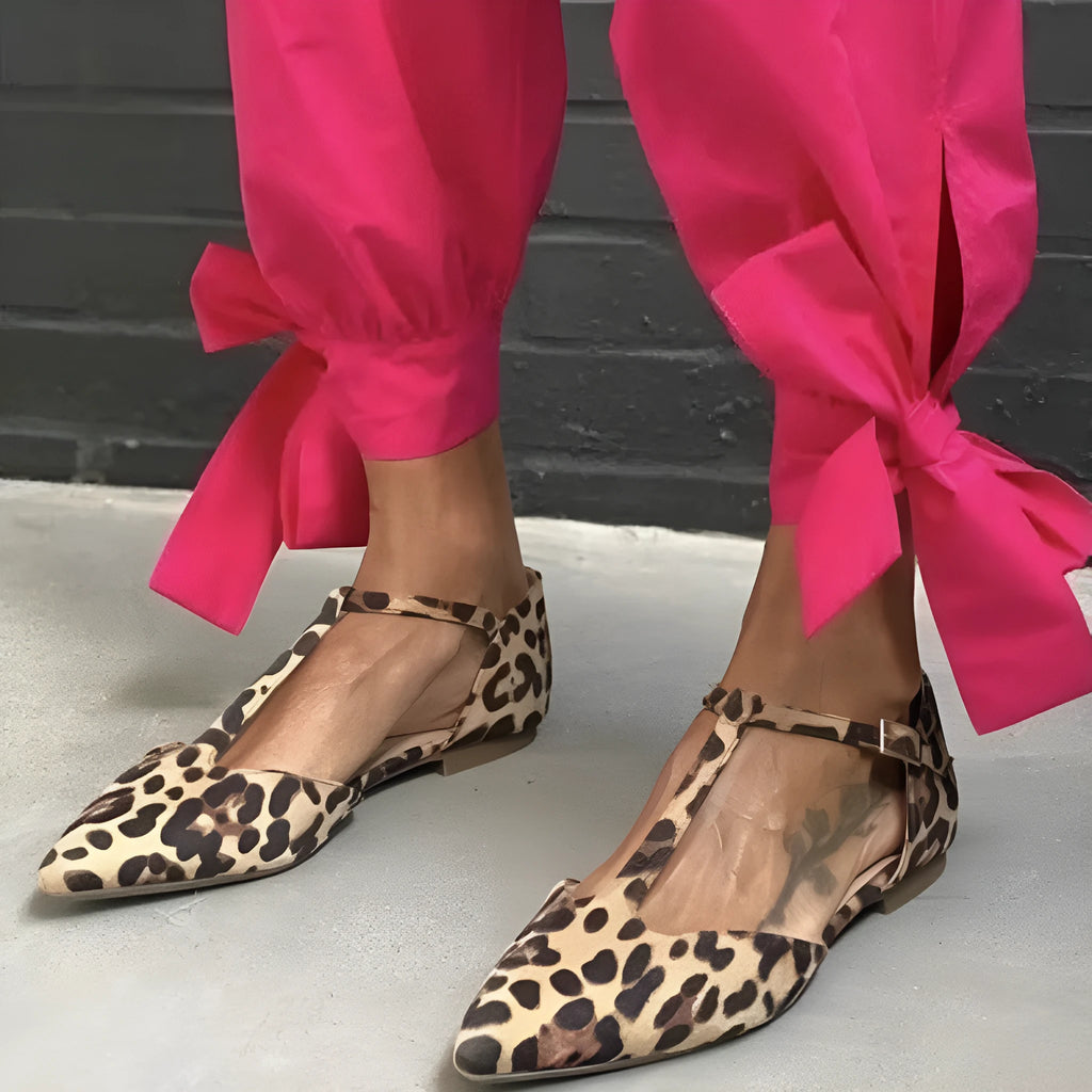 Leopard print women's pumps with pointed toe, chunky low heel, and ankle cross strap.