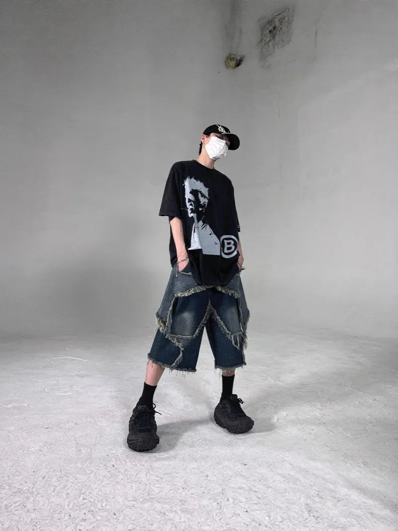 Men's blue denim shorts with loose retro fit, frayed details, and five-pointed star motif on micro-elastic cotton fabric