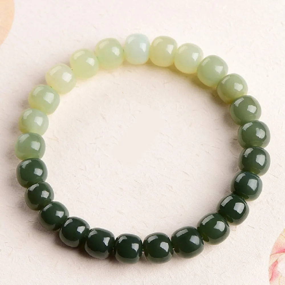 Natural Hetian jade bracelet with clear water gradient on wrist.