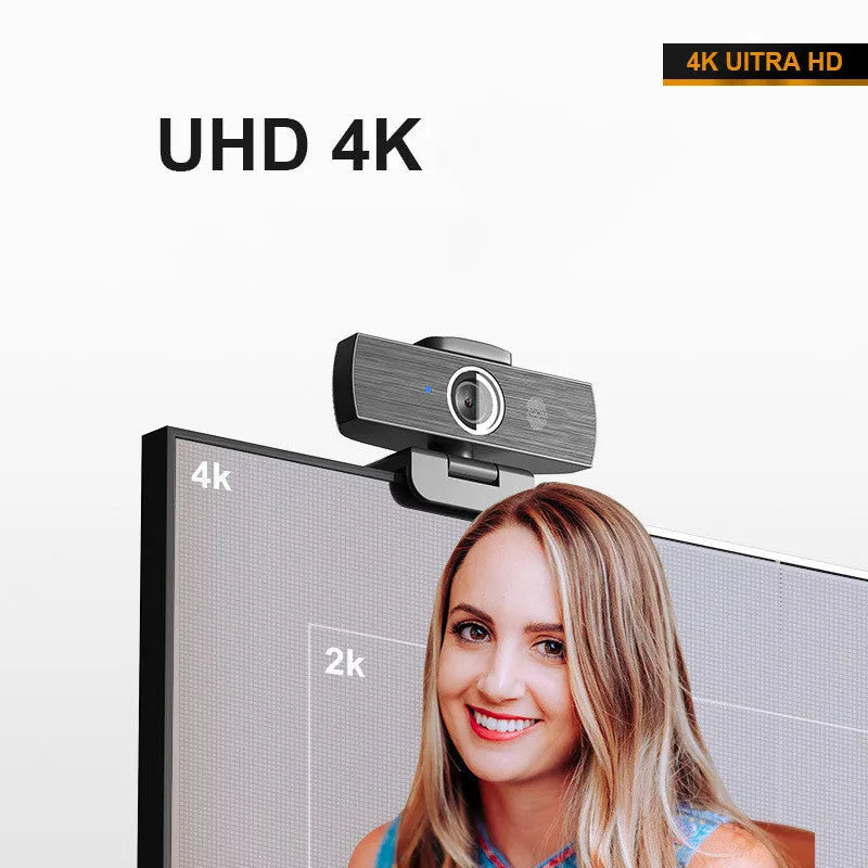Black USB computer webcam with magnetic privacy cover on a desktop