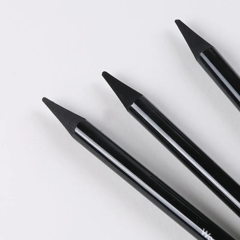 Set of six graphite pencils and three carbonized pencils in wooden casings on suction card packaging.