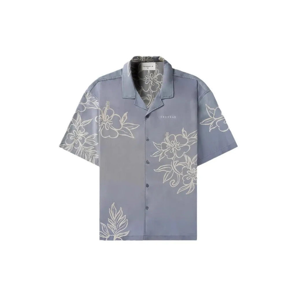 Man wearing a loose, light grey printed short sleeve casual top made from stretch polyester fabric.