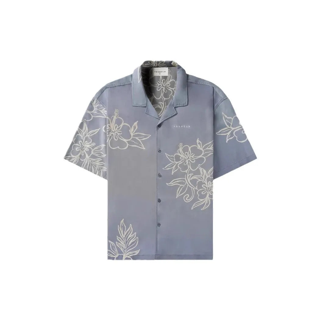 Man wearing a loose, light grey printed short sleeve casual top made from stretch polyester fabric.
