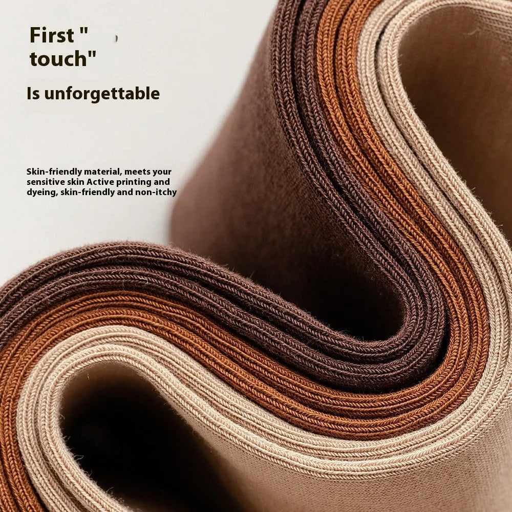 Pack of men's solid colour mid-calf business socks in combed cotton on a neutral background.