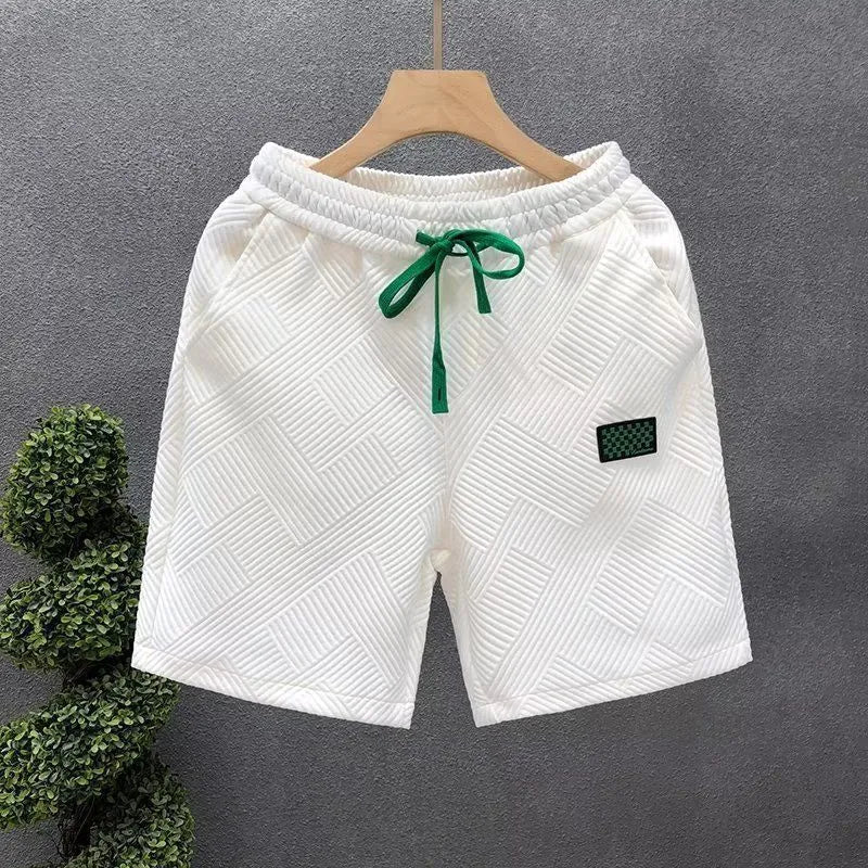 Men's solid colour polyester casual sports shorts with elastic waistband in white, black, or green.